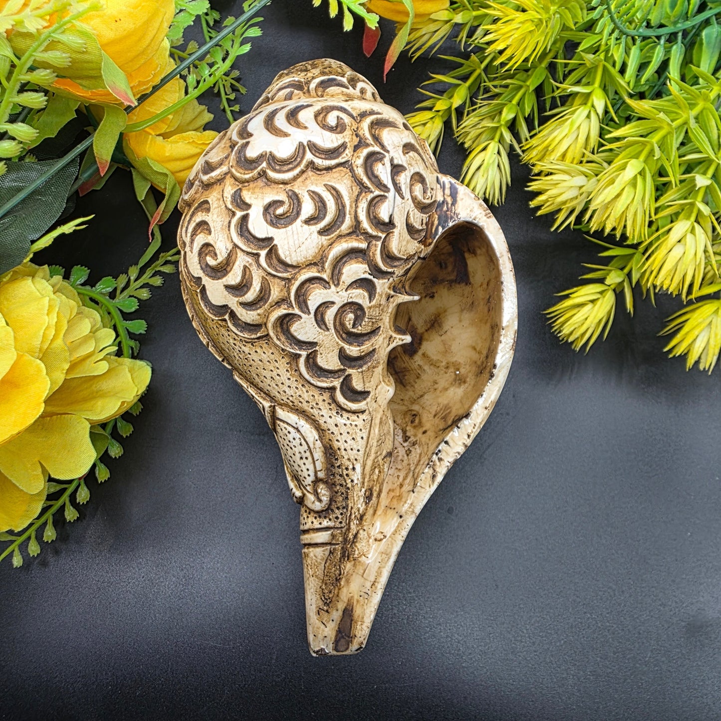 Side view of Ram Sita carved Vamavrati conch shell showing detailed craftsmanship