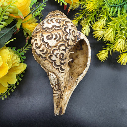Side view of Ram Sita carved Vamavrati conch shell showing detailed craftsmanship