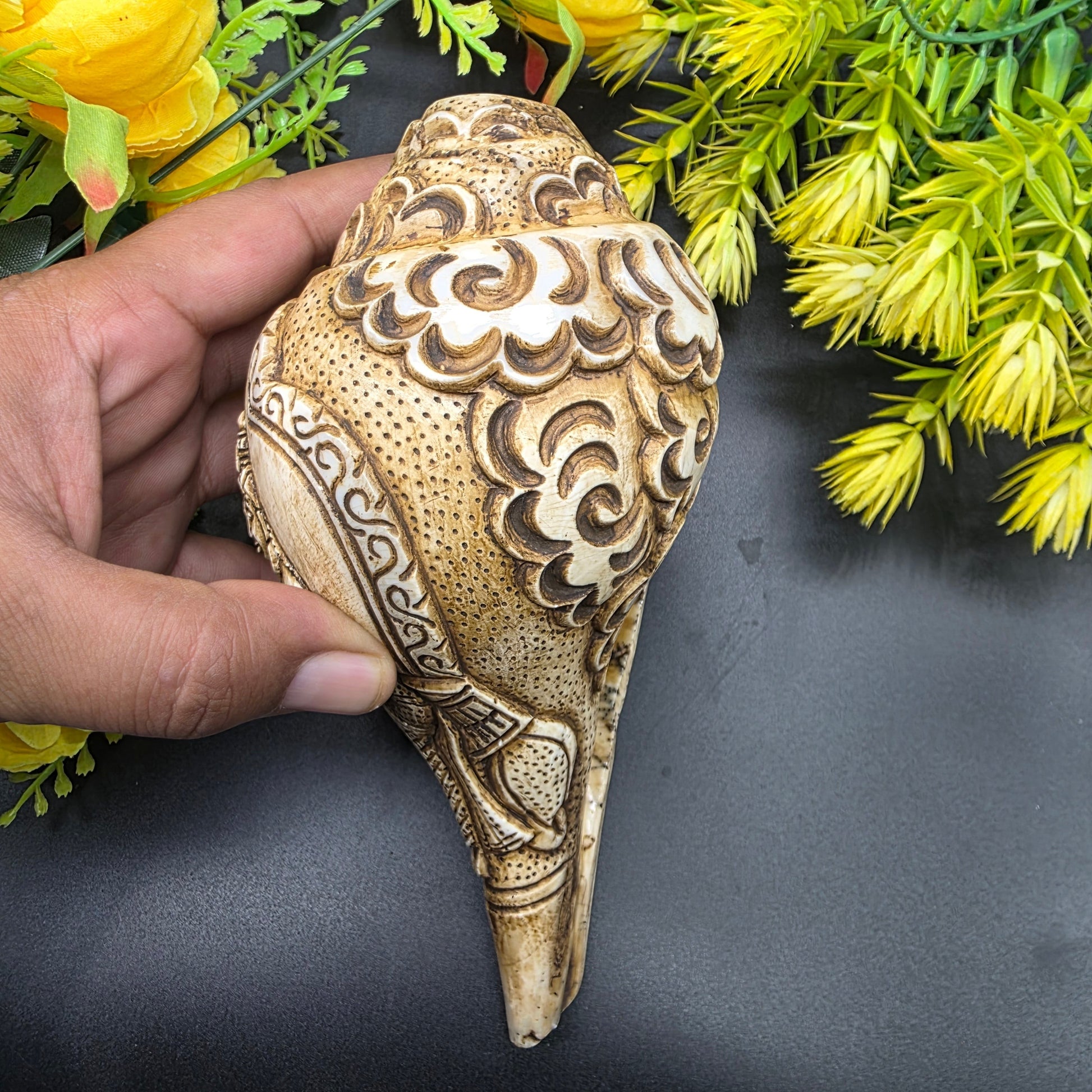 Close-up of Ram Sita artwork hand-carved on natural pooja shankh