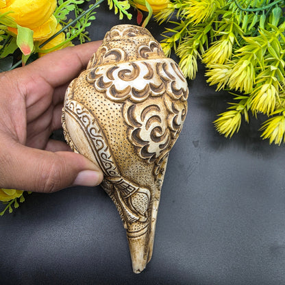 Close-up of Ram Sita artwork hand-carved on natural pooja shankh